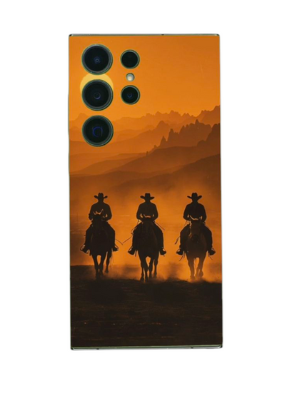 Cowboy-ratsastajat oranssia taustaa vasten